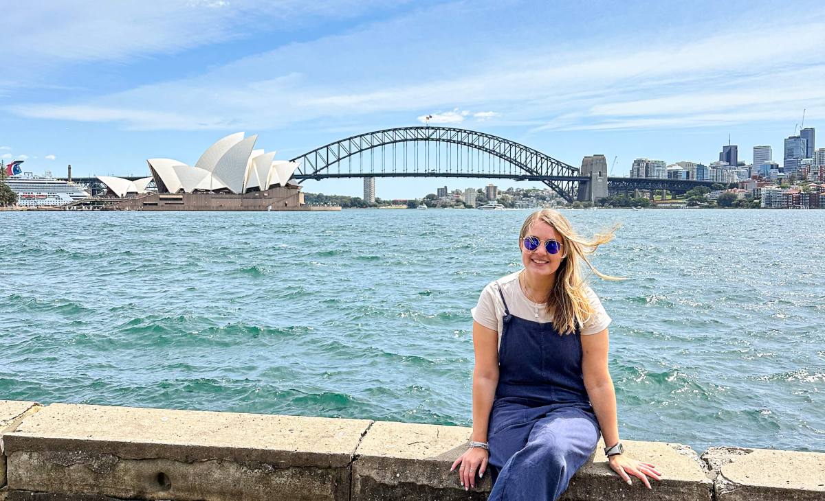 Charlie sat in Sydney with the Harbour Bridge behind her, ready to embark on her epic trip as she takes a career break in her 30's