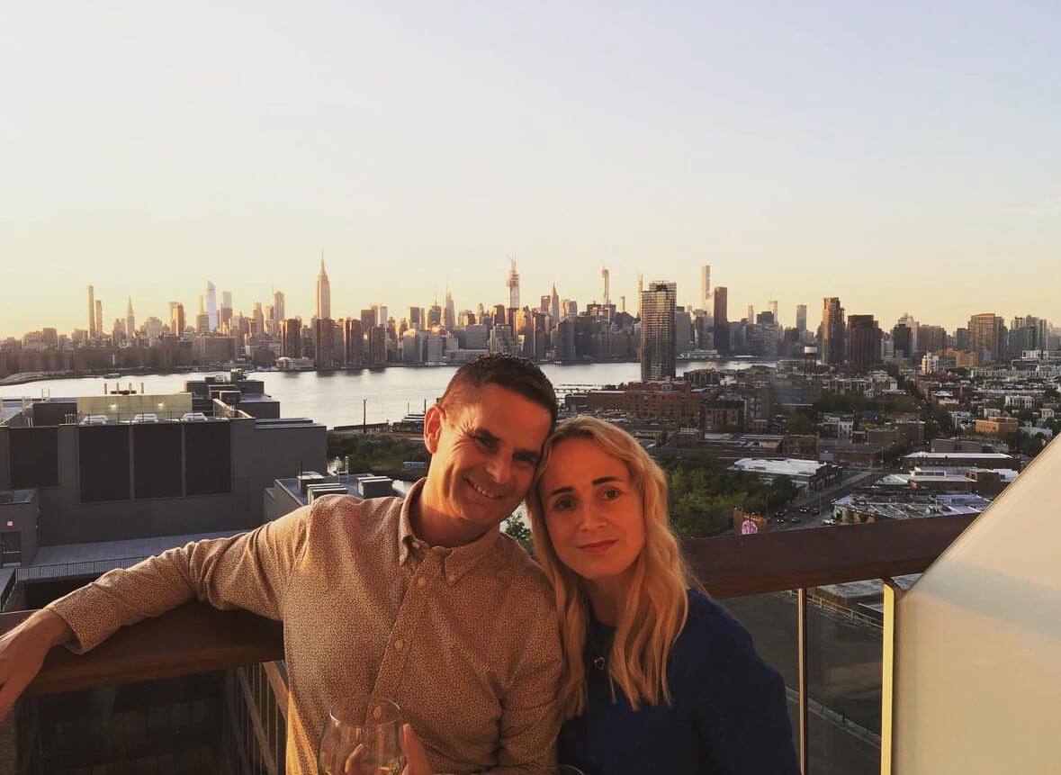 The Happy Couple the night before their New York Wedding with the New York skyline behind at sunset