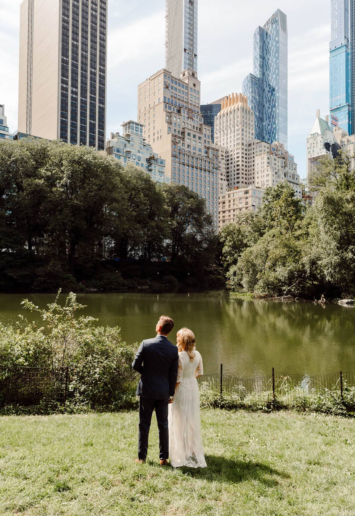 The happy couple in Central Park, looking pu to the New York skyline - a New York wedding